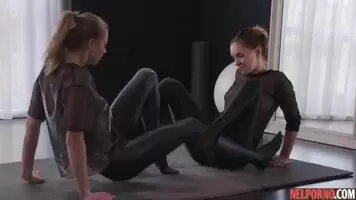 Lesbians in latext caress each other with strap-ons