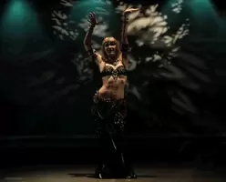 This time she went to the center of the room and did a snake-like dance to the slow music.