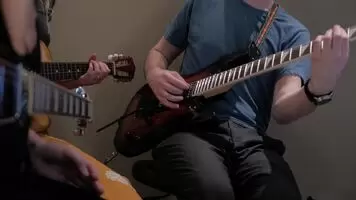 Guitar teacher has a bit of a wardrobe malfunction in front of students